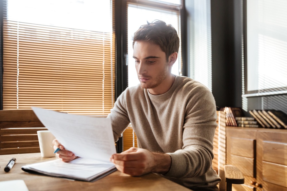 Homeowner reviewing HOA governing documents including CC&Rs and bylaws