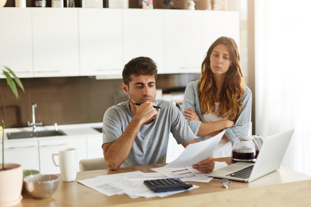 Homeowner reviewing HOA budget and bank statements for signs of misuse of funds