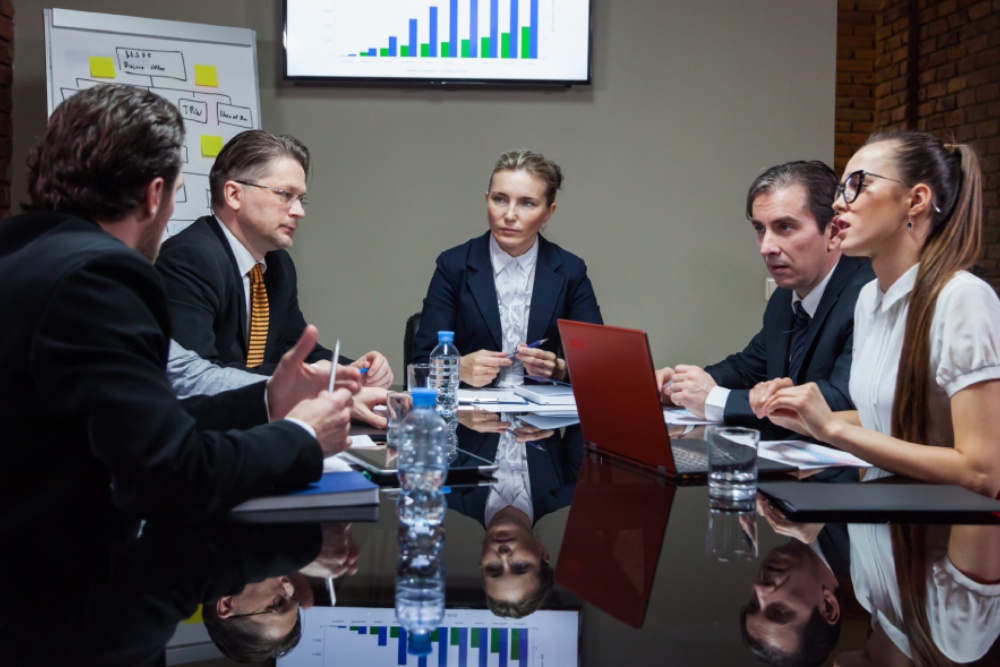 HOA board meeting where directors review financial reports, illustrating HOA board fiduciary duties