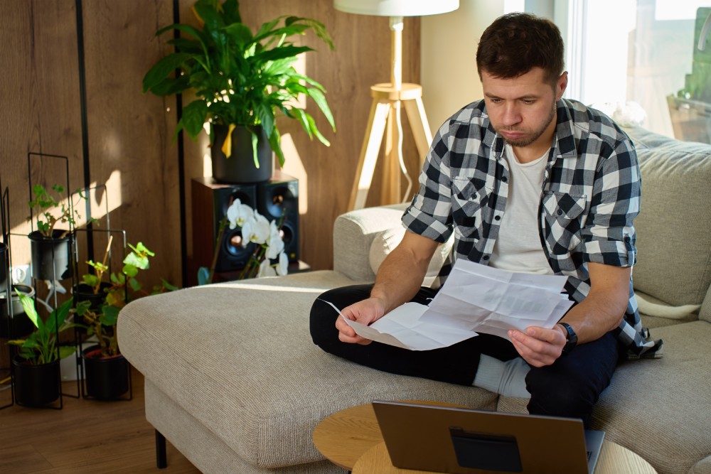 hoa-dues-increase Homeowner reviewing an HOA budget report and notice of an HOA dues increase