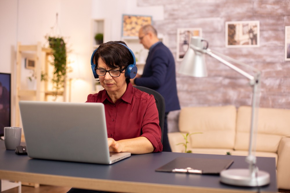 Homeowner working at a home office desk in a planned community, illustrating a home business in an HOA