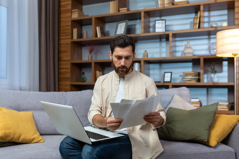 hoa-lien.jpg Homeowner reading a recorded HOA lien notice at home, illustrating what an HOA lien means