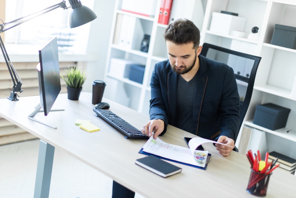 hoa-management-company Community manager reviewing association files in an HOA management company office