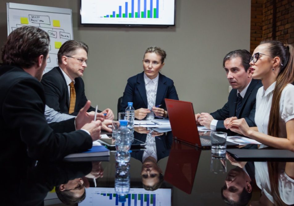 HOA board meeting where directors review financial reports, illustrating HOA board fiduciary duties