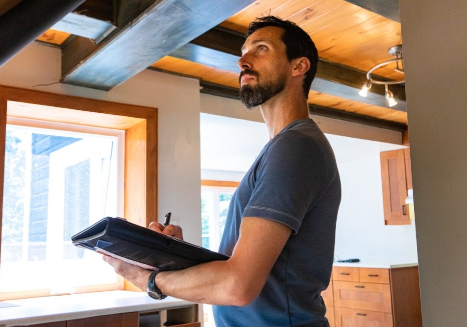 Condo owner documenting a ceiling leak to determine HOA common area repair responsibility