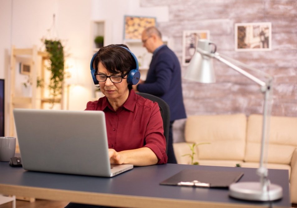 Homeowner working at a home office desk in a planned community, illustrating a home business in an HOA