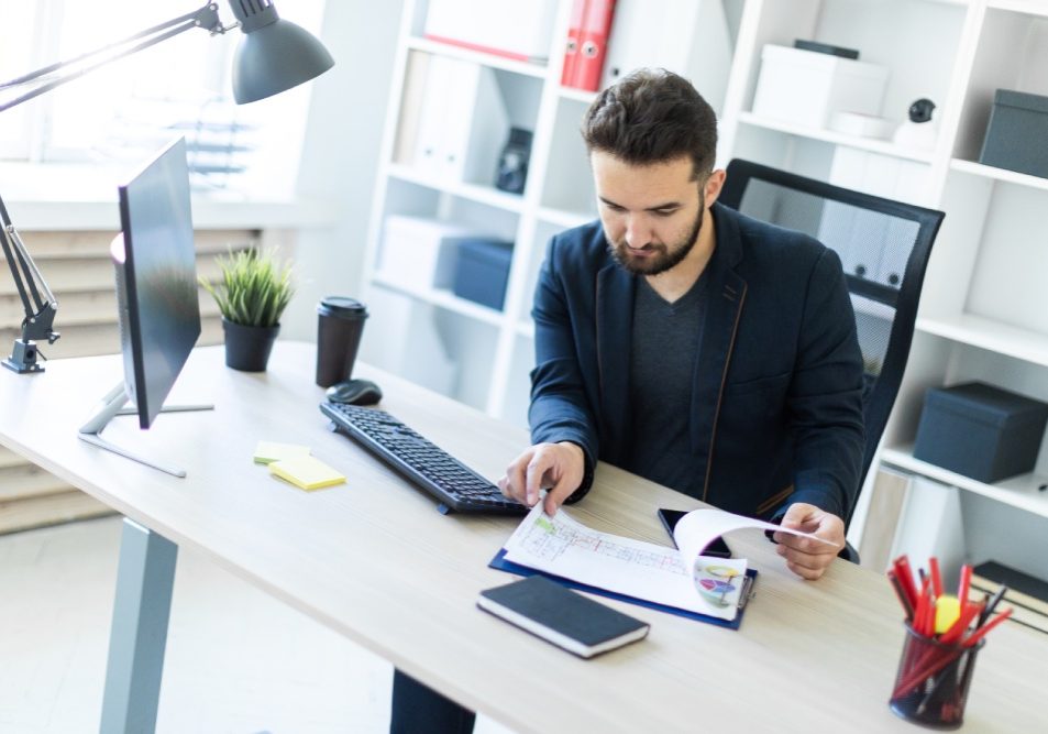 Community manager reviewing association files in an HOA management company office