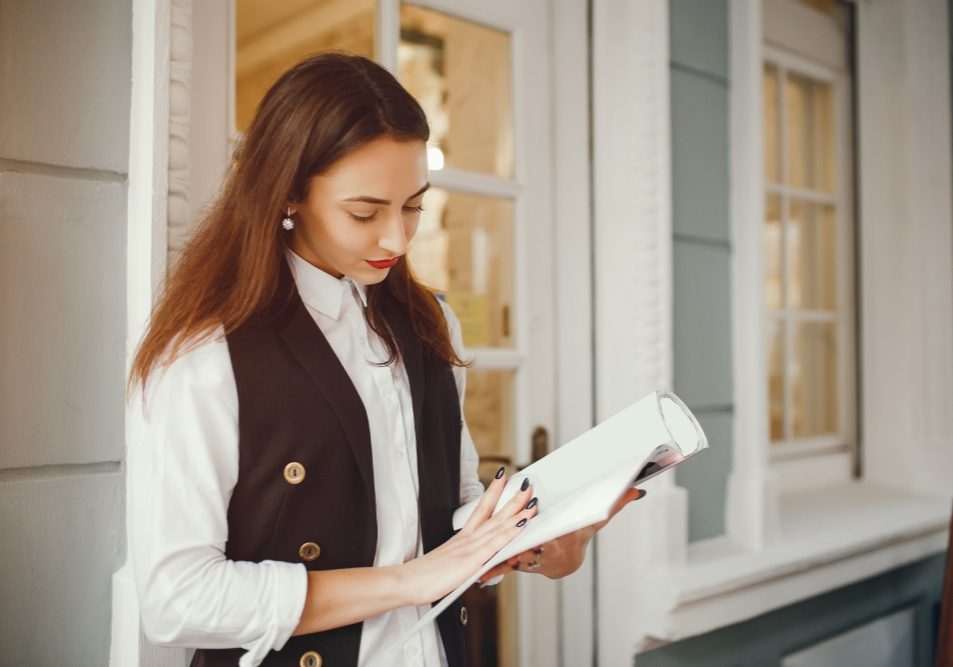 Homeowner reading an HOA violation notice at the front door